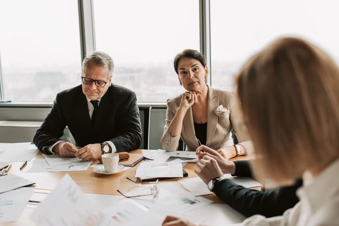 Business professionals reviewing financial documents together in an office