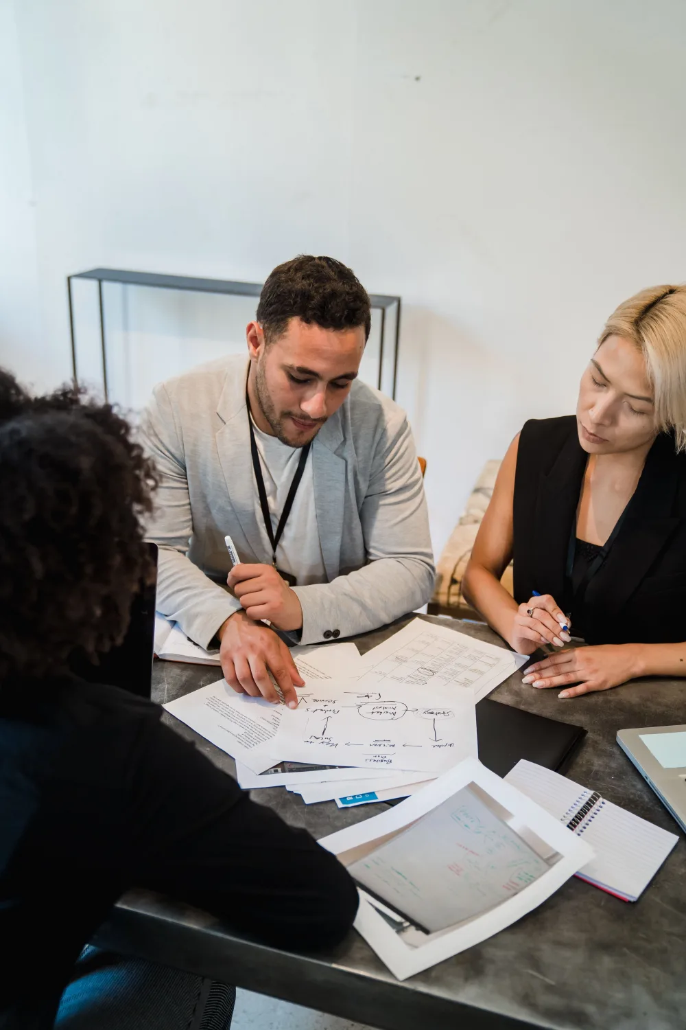 A diverse business team reviewing plans and documents at a meeting table